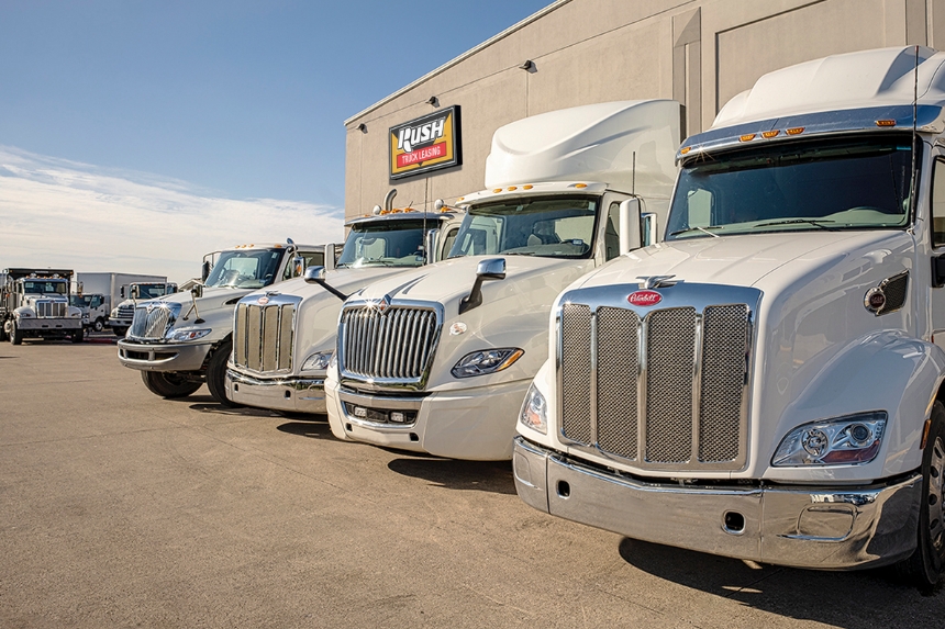 Peterbilt and International trucks in front of Rush Truck Leasing building