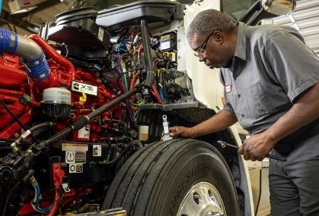 Technician working on truck wheel